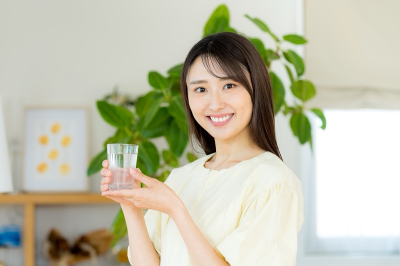 朝に水を飲む爽やかな女性