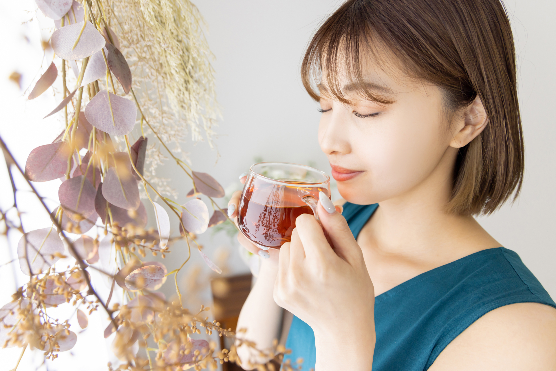 入浴後に水分補給して休む女性のイメージ