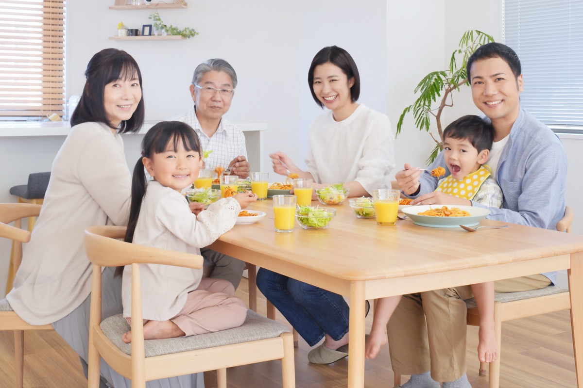 家族で朝食のヨーグルトを囲むテーブルのイメージ